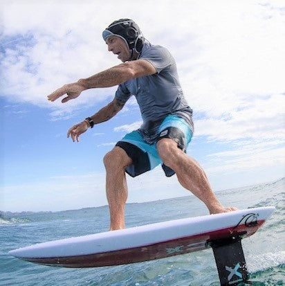 Tom Carroll wearing a DMC Soft Surf Helmet while foiling